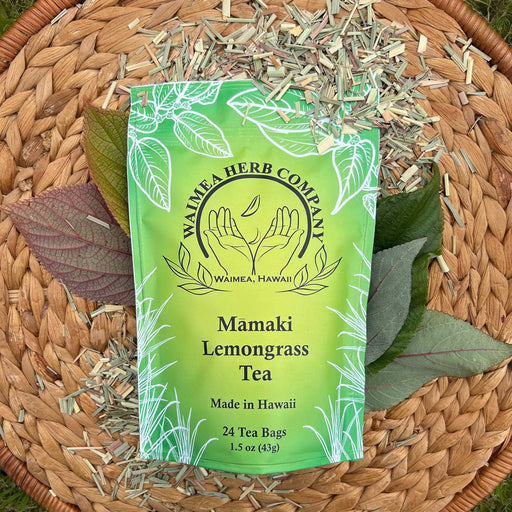 Waimea Herb Company Mamaki Lemongrass Tea package on a woven mat with tea leaves.