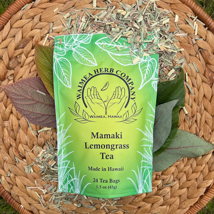 Waimea Herb Company Mamaki Lemongrass Tea package on a woven mat with tea leaves.