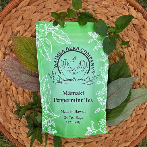 Waimea Herb Company Mamaki Peppermint Tea package on a woven mat with leaves
