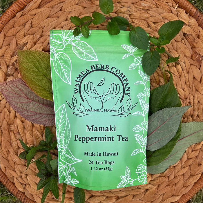 Waimea Herb Company Mamaki Peppermint Tea package on a woven mat with leaves