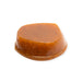A single dome-shaped POG fruit paste with a glossy amber-brown surface and small dark specks, isolated on a plain white background.