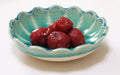 red umeboshi in a small blue bowl