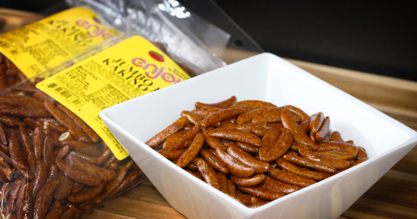 Enjoy Jumbo Hot Kakinotane in a bowl with two 8 oz bags in the background
